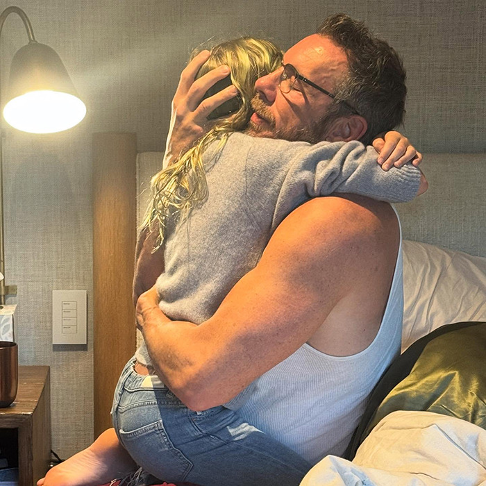 Man in a white tank top hugging a child in a cozy room, highlighting Kristen Bell and Dax Shepard's toxic marriage issues. Man in a white tank top hugging a child in a cozy room, highlighting Kristen Bell and Dax Shepard's toxic marriage issues.