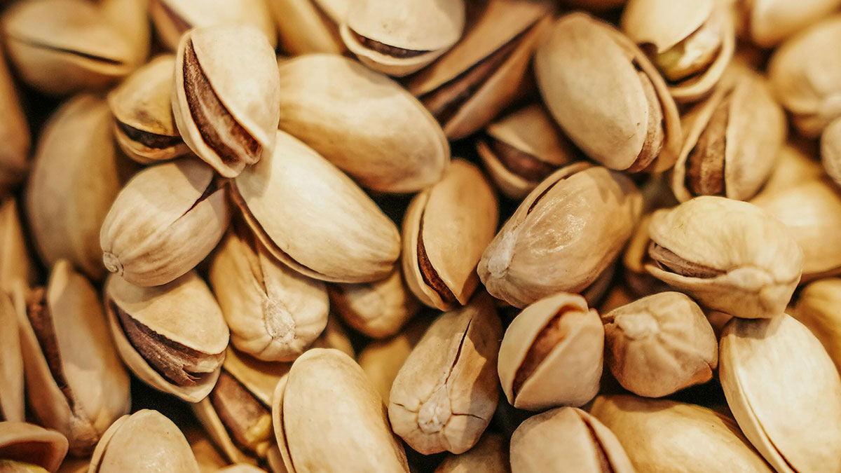 Close-up of pistachios showing a life hack for easily opening shells, inspired by accidental discoveries.