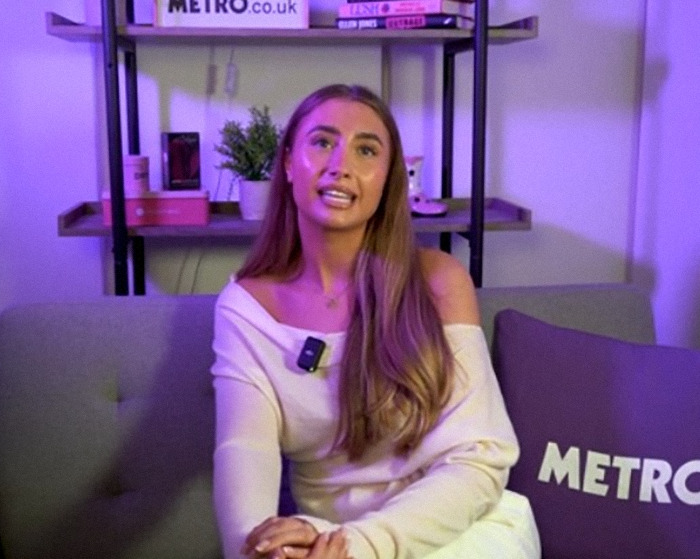 Lily Phillips speaking in an interview setting with Metro-branded cushions and shelves in the background. Lily Phillips speaking in an interview setting with Metro-branded cushions and shelves in the background.