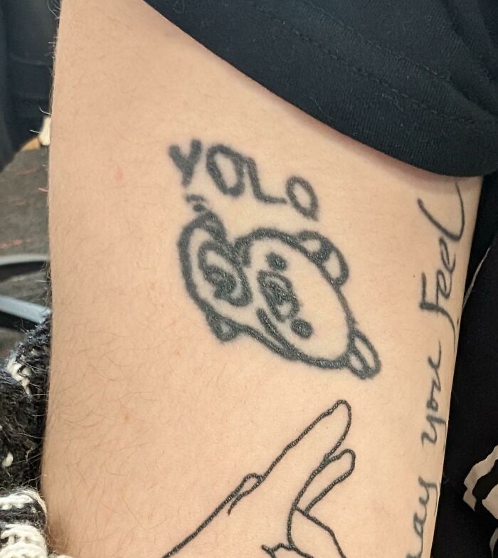Tattoo with poorly drawn bear face and YOLO text, showing an example of when tattoo artists drew the line with requests.