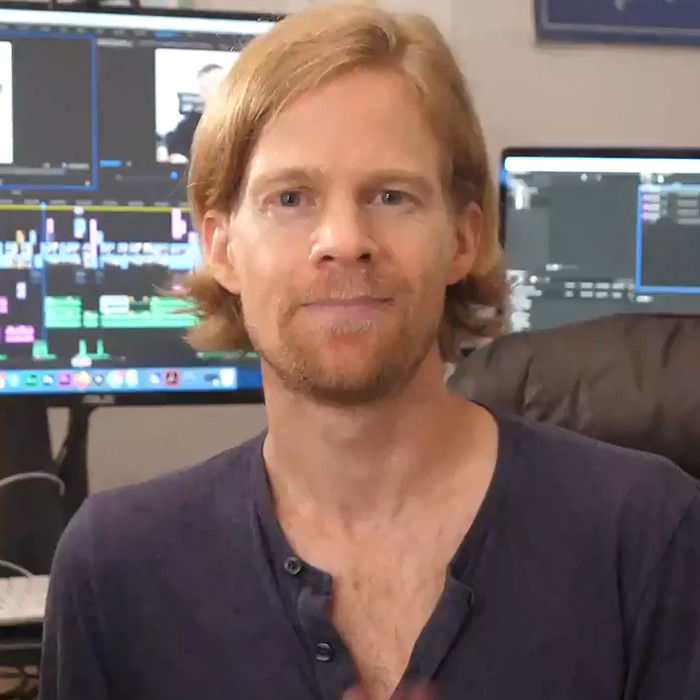 Man behind blinking guy GIF with red hair and beard sitting in front of computer screens in a casual home office setting. Man behind blinking guy GIF with red hair and beard sitting in front of computer screens in a casual home office setting.