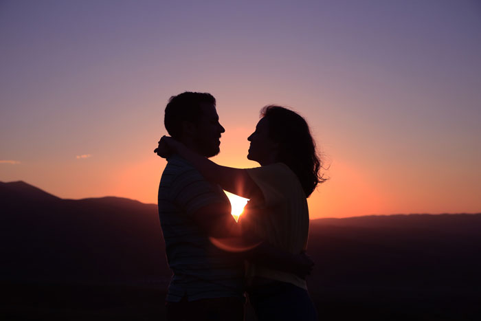 Silhouette of a young couple embracing at sunset, symbolizing a 19YO choosing parents over 27YO girlfriend and child. Silhouette of a young couple embracing at sunset, symbolizing a 19YO choosing parents over 27YO girlfriend and child.
