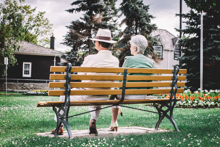 Elderly parents sitting on a park bench, symbolizing a 19YO choosing his parents over his 27YO girlfriend. Elderly parents sitting on a park bench, symbolizing a 19YO choosing his parents over his 27YO girlfriend.