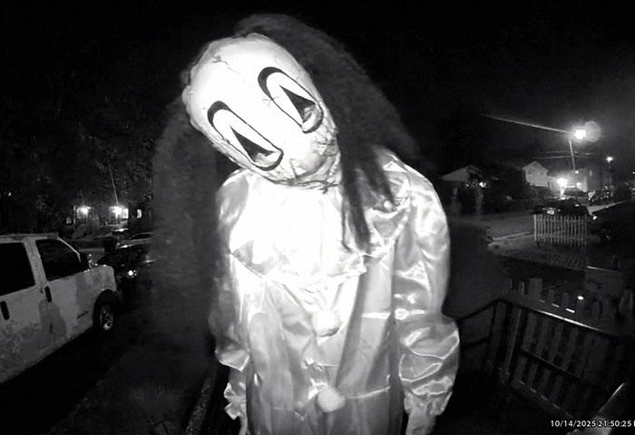 Masked figure in a disturbing doorbell prank captured at night with eerie lighting and neighborhood background. Masked figure in a disturbing doorbell prank captured at night with eerie lighting and neighborhood background.