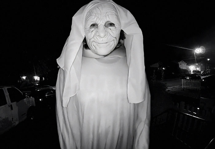 Masked figure in eerie costume captured at night during disturbing doorbell prank with a staggering twist revealed later. Masked figure in eerie costume captured at night during disturbing doorbell prank with a staggering twist revealed later.