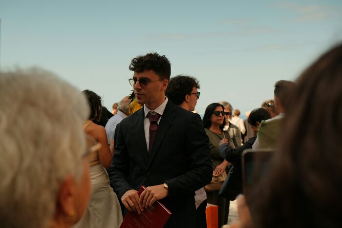 Man in sunglasses and black suit at an outdoor event, representing an innocent worker in a boss wife affair claim scenario. Man in sunglasses and black suit at an outdoor event, representing an innocent worker in a boss wife affair claim scenario.