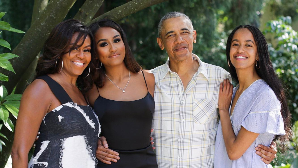 Michelle Obama with family outdoors, smiling together, addressing marriage and divorce rumors in recent headlines.