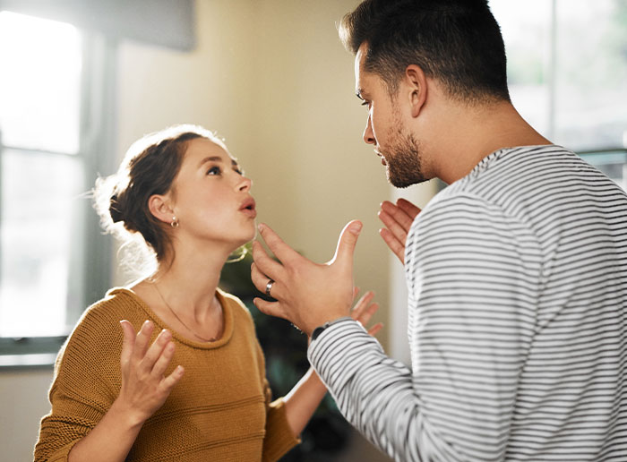 Couple having a heated argument indoors, illustrating tension as guy runs out the window after reconciliation attempt. Couple having a heated argument indoors, illustrating tension as guy runs out the window after reconciliation attempt.