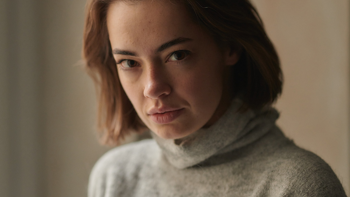 Young woman in a gray turtleneck looking somber, reflecting on mom daughter conflict and refusal to reconcile years later