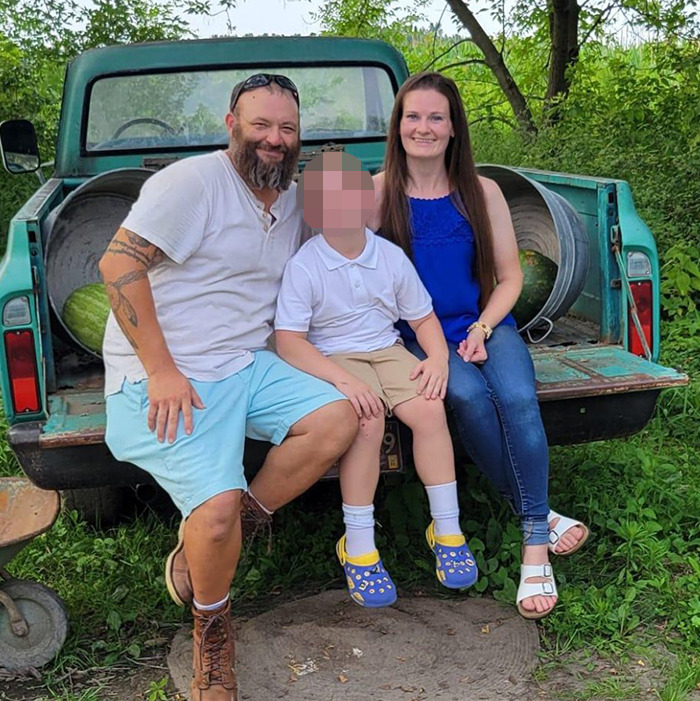 Family sitting on the back of a truck in a green outdoor area, related to Mormons raising money controversy. Family sitting on the back of a truck in a green outdoor area, related to Mormons raising money controversy.