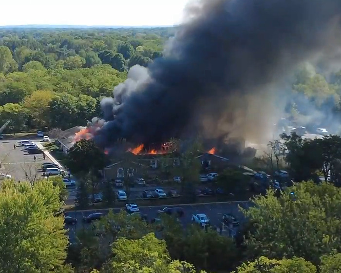 Large fire and thick smoke engulf a Michigan church attacked by a man while many cars are parked nearby in the lot. Large fire and thick smoke engulf a Michigan church attacked by a man while many cars are parked nearby in the lot.