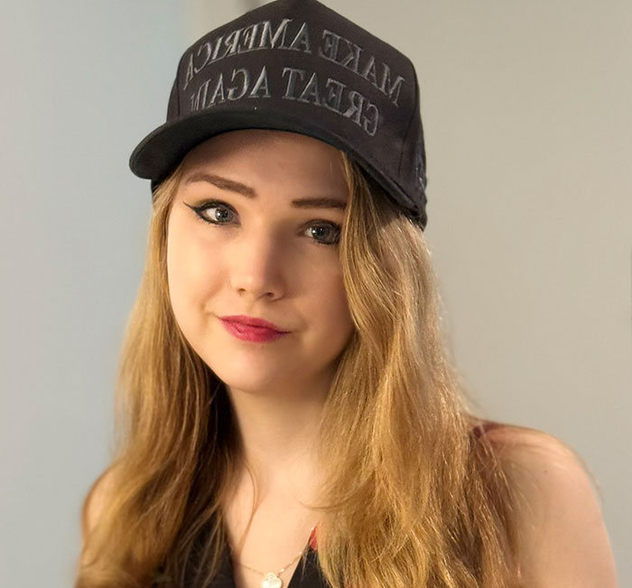 German activist known as Anti-Greta wearing a cap, seeking asylum in the US after encouragement from Elon Musk.