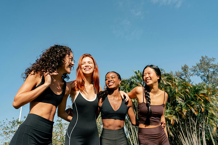 Group of four women enjoying outdoor group activities, highlighting challenges faced by a mom of 4 with kids. Group of four women enjoying outdoor group activities, highlighting challenges faced by a mom of 4 with kids.