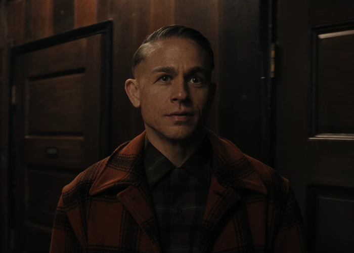 Man in a checkered coat standing indoors in a dimly lit room, related to Netflix's Monster The Ed Gein story details. Man in a checkered coat standing indoors in a dimly lit room, related to Netflix's Monster The Ed Gein story details.