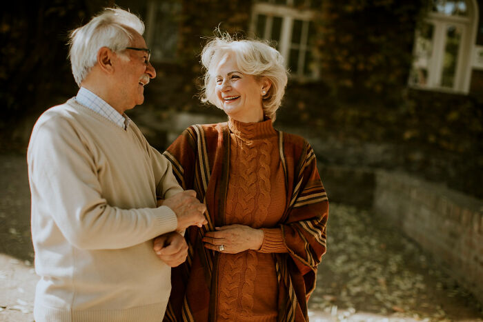 Elderly couple smiling outdoors, illustrating moments patients swore everything was fine while doctors noticed issues.