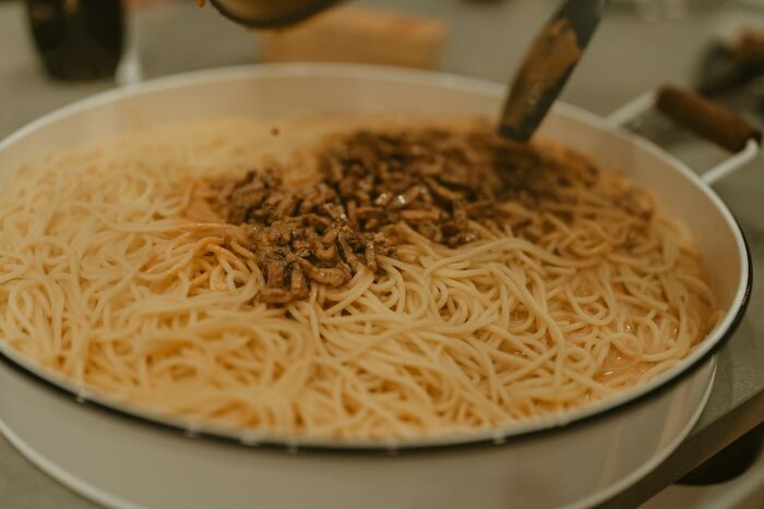 Shrimp jello dish served in a round pan with cooked noodles and small shrimp pieces on top in a home setting. Shrimp jello dish served in a round pan with cooked noodles and small shrimp pieces on top in a home setting.