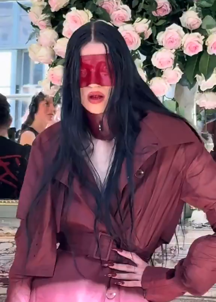 Model with long black hair wearing a red face mask and oversized jacket at Paris Fashion Week boundary-breaking show. Model with long black hair wearing a red face mask and oversized jacket at Paris Fashion Week boundary-breaking show.