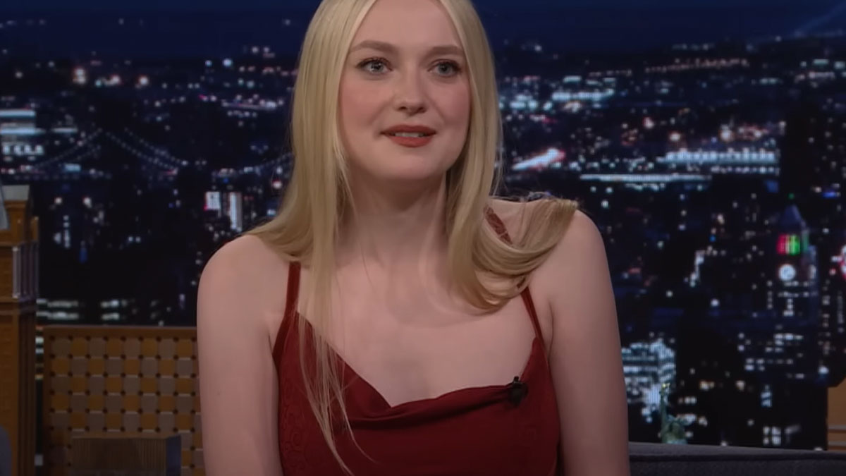 Young woman in a red dress sharing a story about celebrity encounters that left a sour taste on a late-night talk show.
