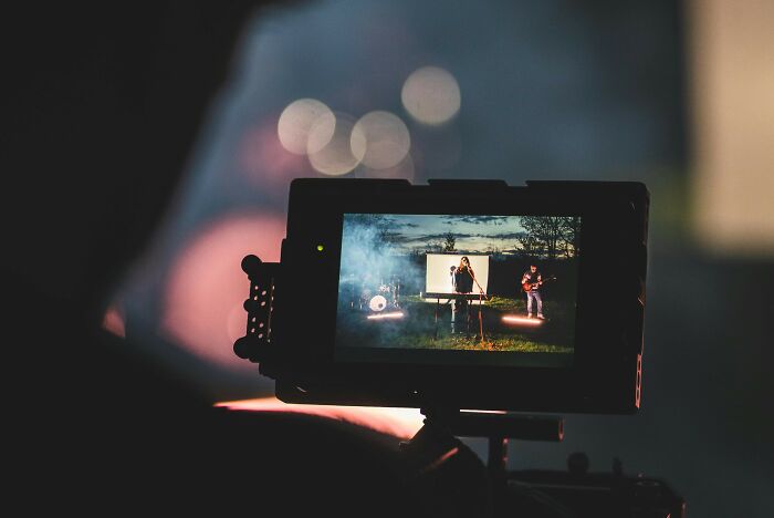 Camera screen showing a band performing outdoors at dusk, capturing an iconic final scene for movie memory test. Camera screen showing a band performing outdoors at dusk, capturing an iconic final scene for movie memory test.