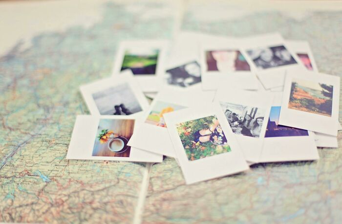 Scattered vintage instant photos on a blurred map background challenging high IQ people to name images perfectly. Scattered vintage instant photos on a blurred map background challenging high IQ people to name images perfectly.