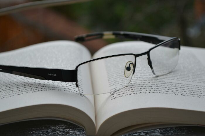 Reading glasses placed on an open book, symbolizing SAT-level vocabulary skills and advanced word knowledge. Reading glasses placed on an open book, symbolizing SAT-level vocabulary skills and advanced word knowledge.