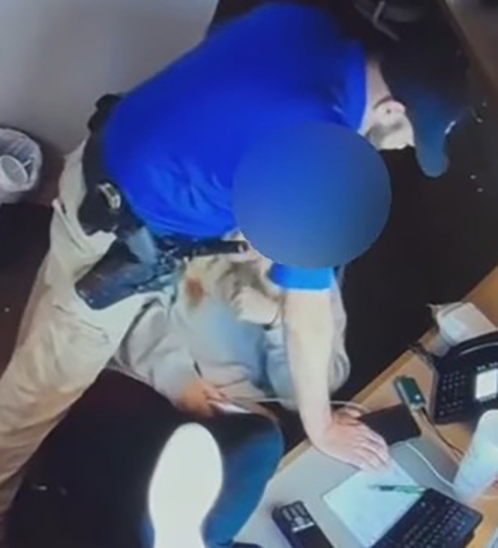 Police chief leans over 18-year-old dispatcher in office setting during disturbing leaked video moment. Police chief leans over 18-year-old dispatcher in office setting during disturbing leaked video moment.