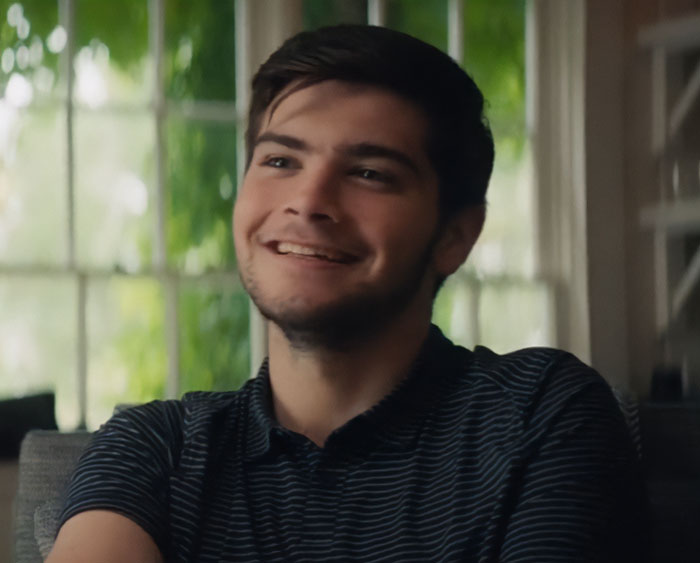 Young man smiling indoors with natural light, relating to Ben Stiller parenting mistakes and nepo baby kids criticism. Young man smiling indoors with natural light, relating to Ben Stiller parenting mistakes and nepo baby kids criticism.