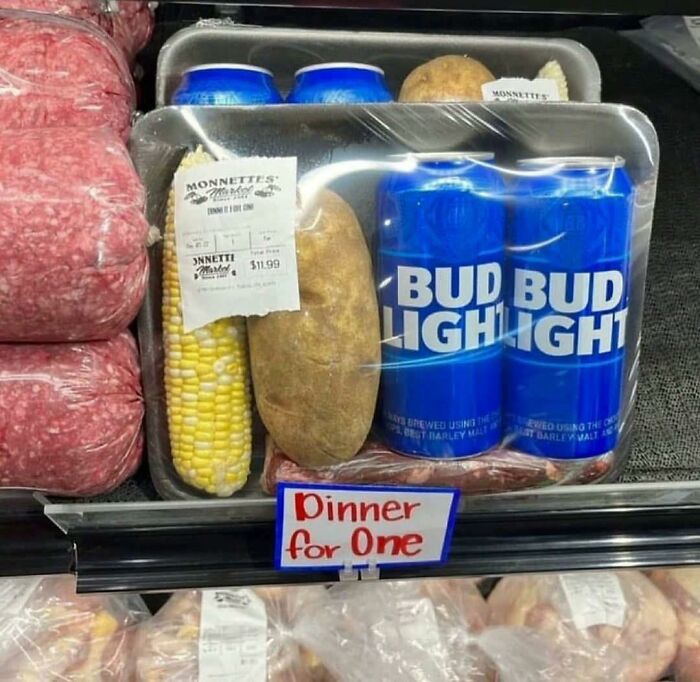 Packaged dinner kit with corn, potato, two cans of beer, and meat, illustrating humorous out of context pleasures of the occult.