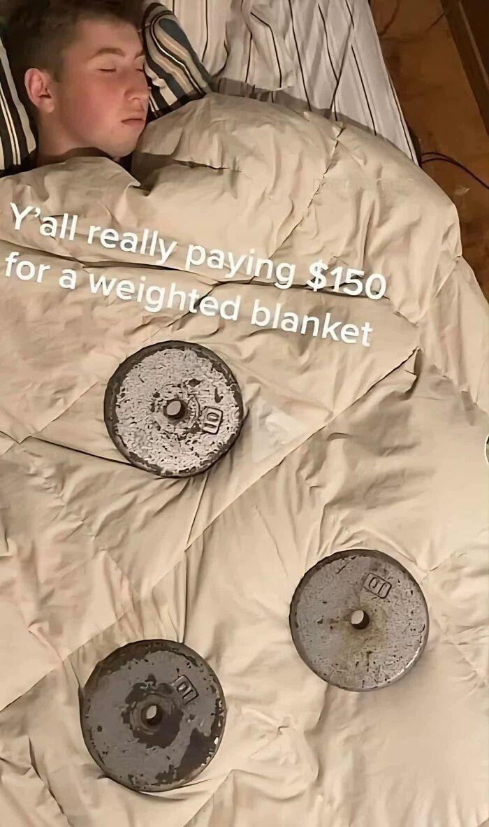 Person sleeping under a blanket with heavy weights on top, highlighting pleasures of the occult humor out of context.