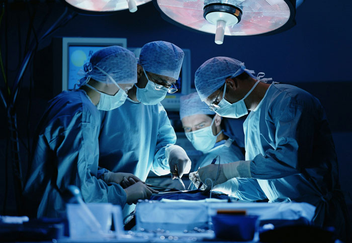 Surgical team performing liver operation in an operating room, illustrating refusing donate liver lawsuit concept.