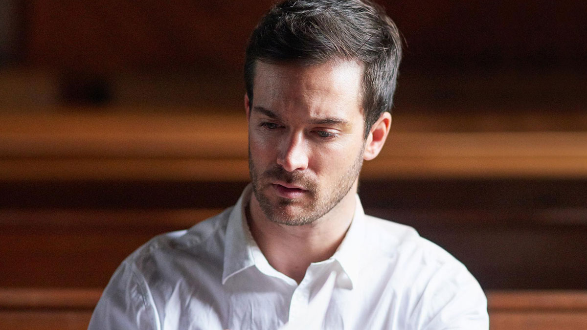 Young man with disability looking down thoughtfully, highlighting rude and ableist things endured by people with disabilities