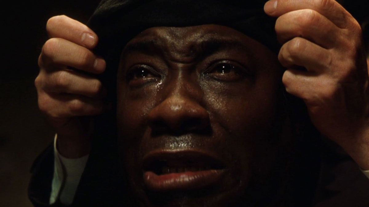 Close-up of a man crying with hands holding his head, capturing emotional lines from movies that tug at the heartstrings.