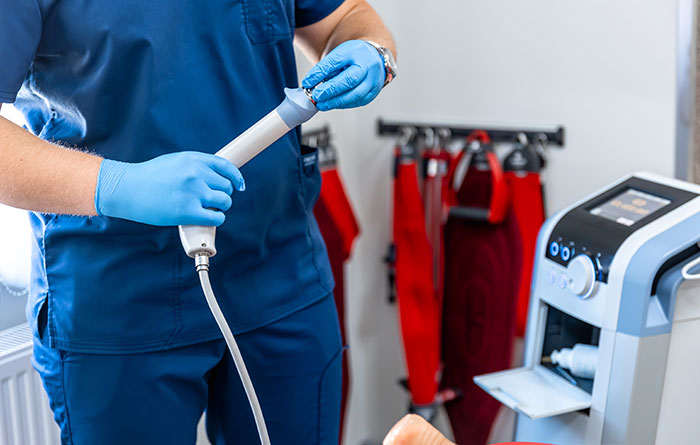 Medical professional in blue scrubs and gloves preparing equipment for a child’s procedure amid mother-daughter accusations. Medical professional in blue scrubs and gloves preparing equipment for a child’s procedure amid mother-daughter accusations.