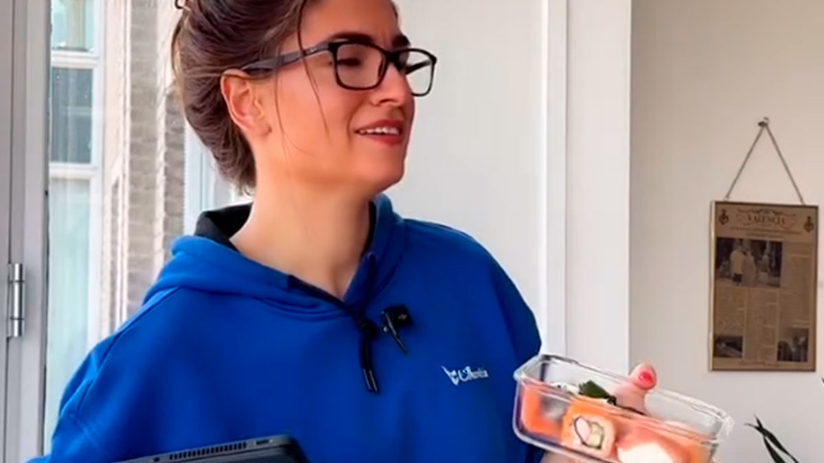 Young woman in glasses holding sushi box, illustrating Bulgarian finding out Dutch donu2019t share food for free culture.