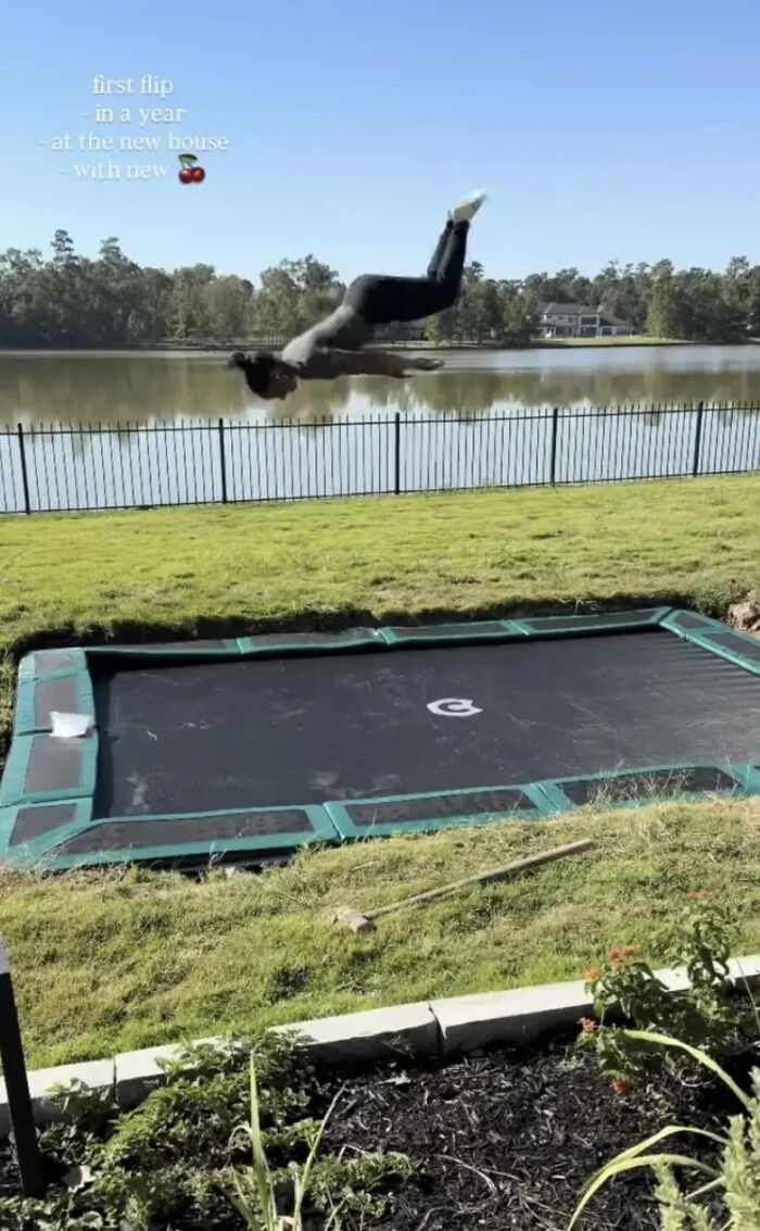 Simone Biles performing a flip on a backyard trampoline near a lake during a sunny day sparking plastic surgery rumors. Simone Biles performing a flip on a backyard trampoline near a lake during a sunny day sparking plastic surgery rumors.