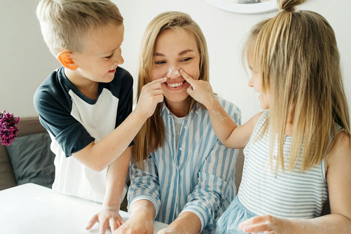 Young kids playfully apply cream on their mom’s nose as family bonds despite challenges with ex-con mom. Young kids playfully apply cream on their mom’s nose as family bonds despite challenges with ex-con mom.
