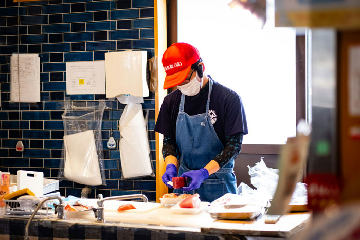 Young adult working in a kitchen wearing a mask and gloves, representing a 20YO mooching off parents scenario. Young adult working in a kitchen wearing a mask and gloves, representing a 20YO mooching off parents scenario.
