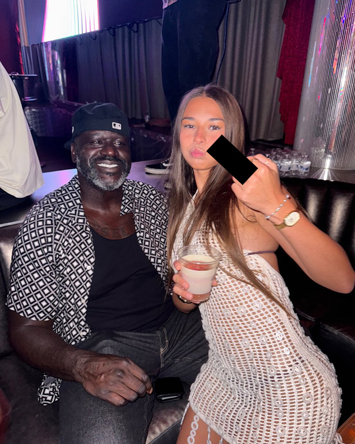 Adult star Sophie Rain sitting with a man at a club, holding a drink, showing a gesture with her hand. Adult star Sophie Rain sitting with a man at a club, holding a drink, showing a gesture with her hand.