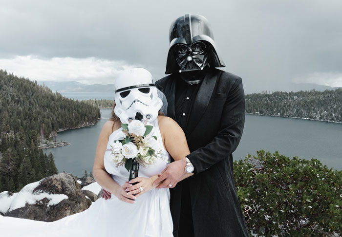 Bride and groom dressed as Star Wars characters pose outdoors at a scenic lake during a themed wedding celebration. Bride and groom dressed as Star Wars characters pose outdoors at a scenic lake during a themed wedding celebration.