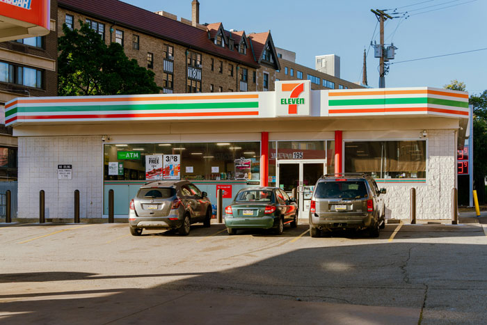 Convenience store exterior with parked cars where a guy believed he was stealing and ended up owing $43.