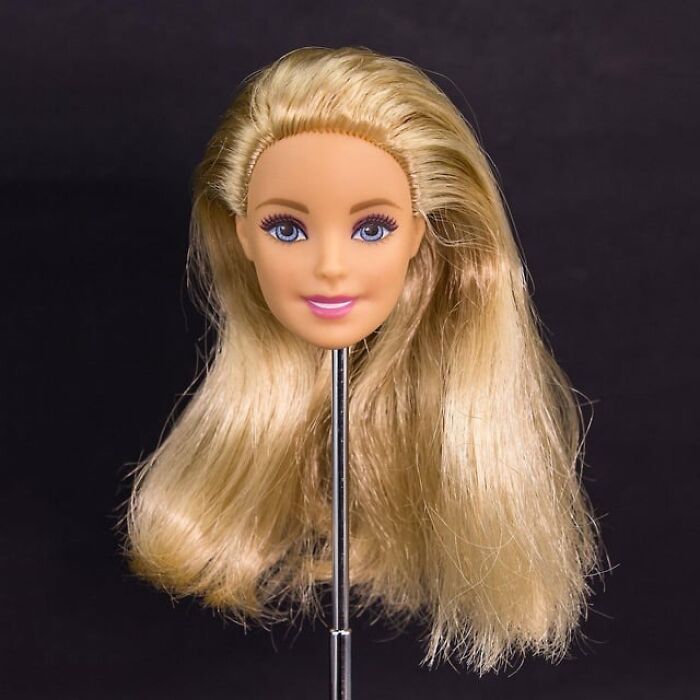 Blonde doll head mounted on a stand, evoking weird things workers have seen inside strangers’ homes.