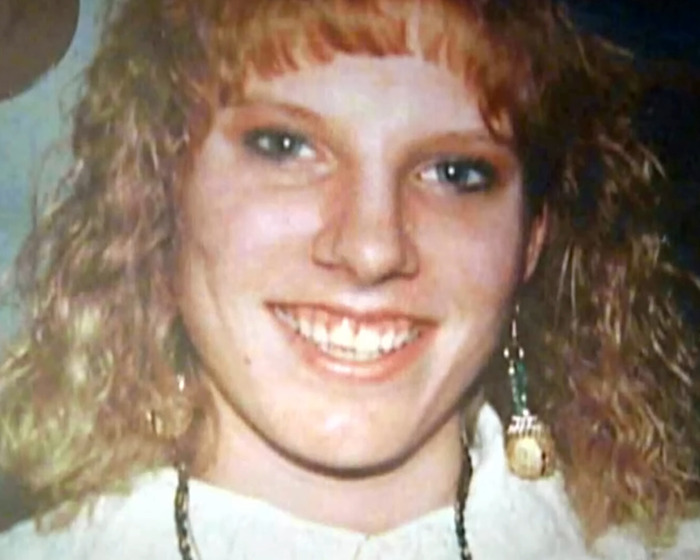 Young woman with curly red hair smiling in a close-up photo related to capital punishment for jealous stabbing case. Young woman with curly red hair smiling in a close-up photo related to capital punishment for jealous stabbing case.