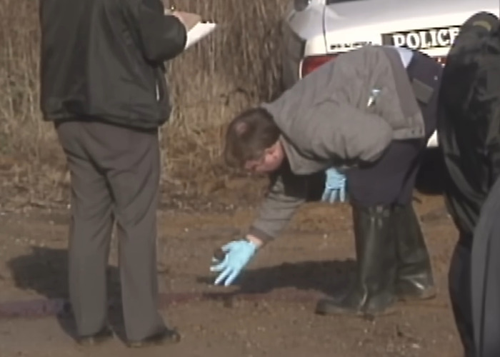 Police investigate crime scene with gloves near vehicle, related to woman’s date for capital punishment after stabbing and pentagram carving. Police investigate crime scene with gloves near vehicle, related to woman’s date for capital punishment after stabbing and pentagram carving.