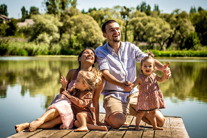 Family enjoying a sunny day by the lake, highlighting the tired mom and let down dad with two young children. Family enjoying a sunny day by the lake, highlighting the tired mom and let down dad with two young children.