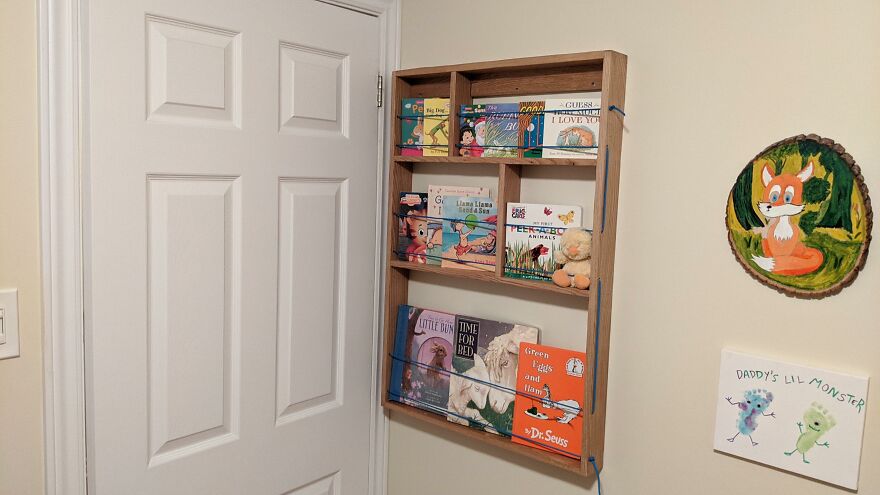 Wooden wall-mounted organizer displaying children's books, demonstrating organization hacks for home storage and space-saving solutions.