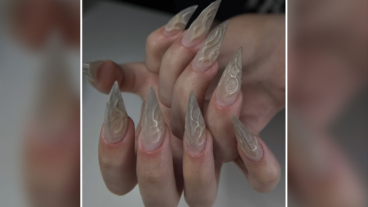 Long pointed nail designs with translucent textured patterns on natural-toned nails breaking traditional rules.
