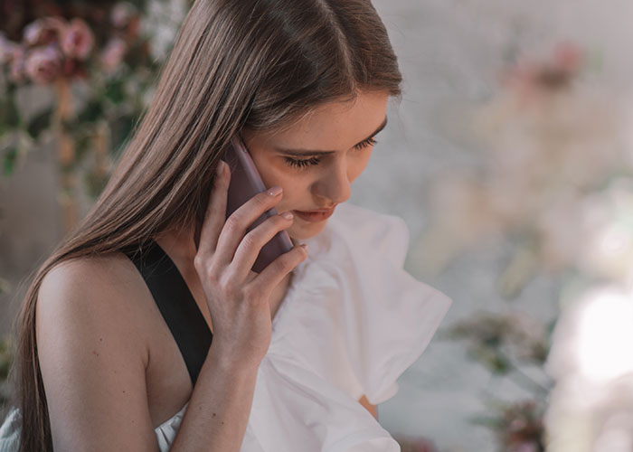 Bride on phone looking concerned while discussing wedding vendors and cupcake allergy issues before event. Bride on phone looking concerned while discussing wedding vendors and cupcake allergy issues before event.