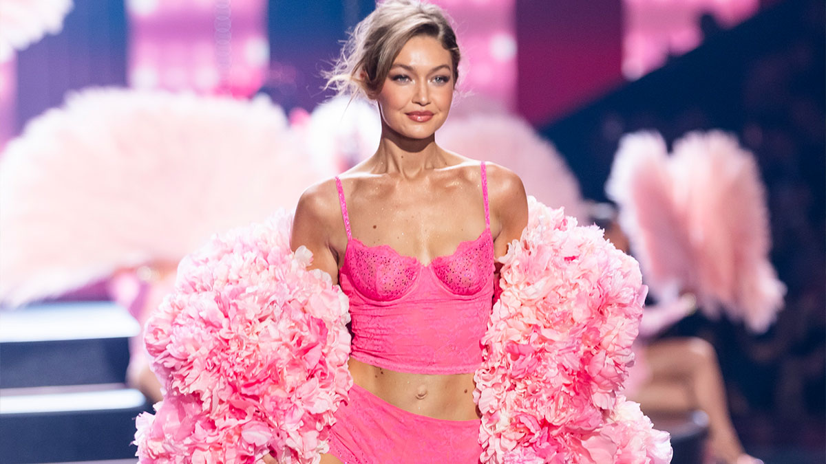 Model in pink lingerie and floral robe showcasing stunning runway looks at the Victoria's Secret Fashion Show 2025.