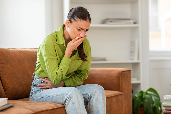 Woman feeling sick and nauseous at home, illustrating symptoms of mysterious illness linked to possible poisoning by ex. Woman feeling sick and nauseous at home, illustrating symptoms of mysterious illness linked to possible poisoning by ex.