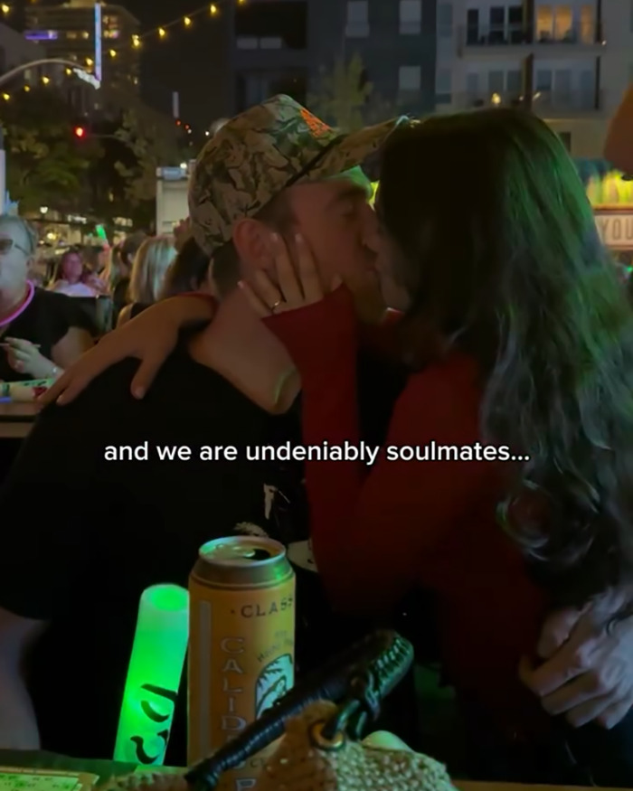 Couple kissing at night in a crowded outdoor setting, symbolizing love life changes after psychic drawing experience. Couple kissing at night in a crowded outdoor setting, symbolizing love life changes after psychic drawing experience.
